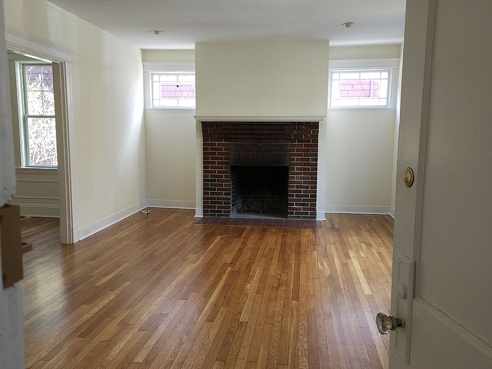 Living room from the front door, large dining room with entrance foyer, window seat, and decorative fireplace