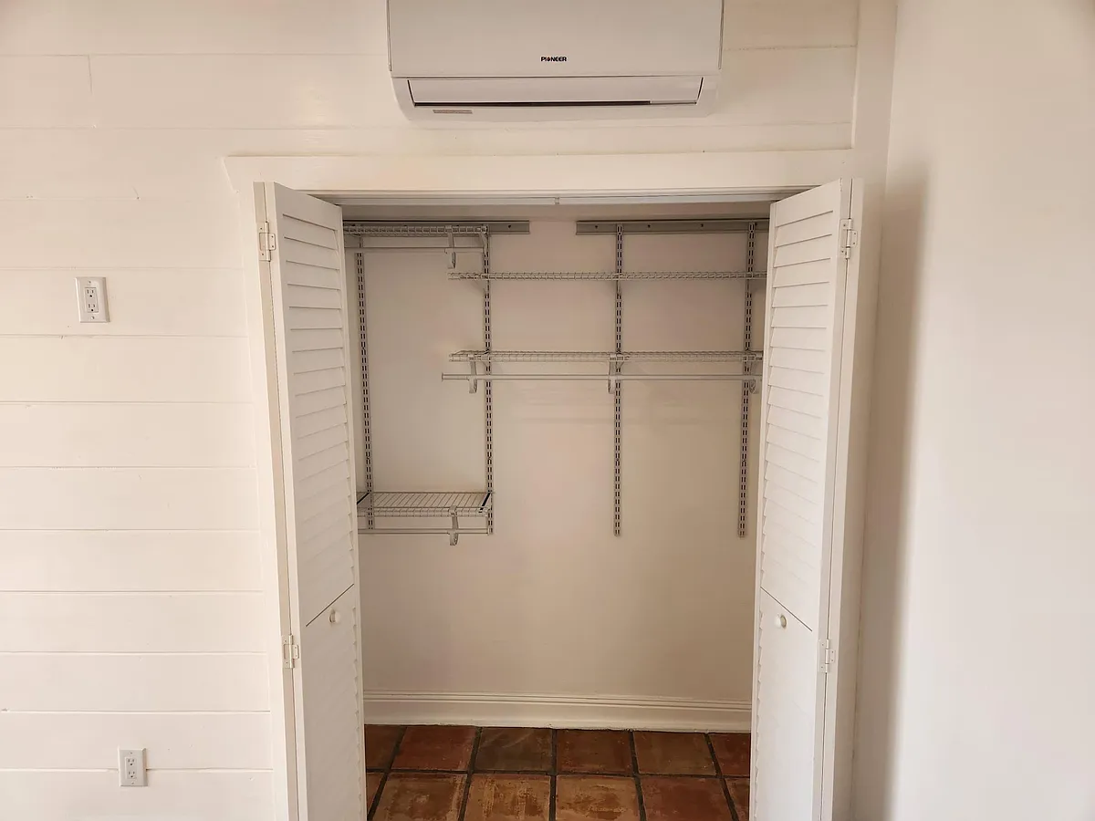 Adjustable closet organization with louvered doors to allow air movement. - 272 Ocean View Dr #A
