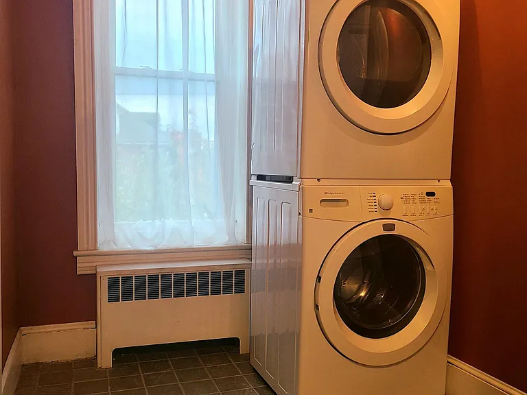 Laundry room off living room; stairs to the 3rd floor bedroom; storage closet