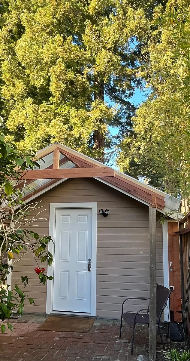 The front entry of the cottage, 7 redwood trees at the neighbor's backyard - 2409 Carleton St