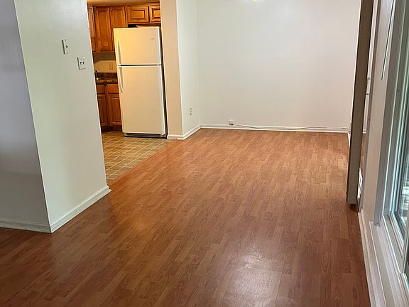 Dining room w/ sliding door on right to concrete patio/exterior storage closet. Kitchen on left.