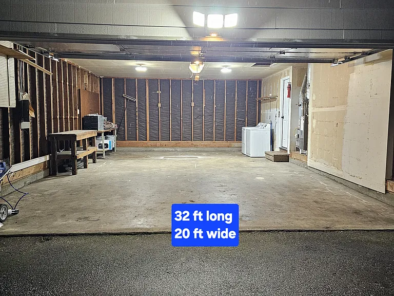 Garage is a two car but can fit four cars. Washer and dryer are in garage. Two work benches. Garage door openers.