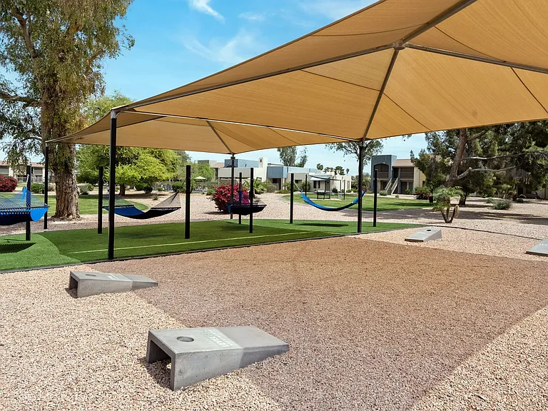 Gather neighbors and friends for an exciting game of cornhole by the hammock garden, infusing vibrancy and playfulness into your day. Fun for everyone!
