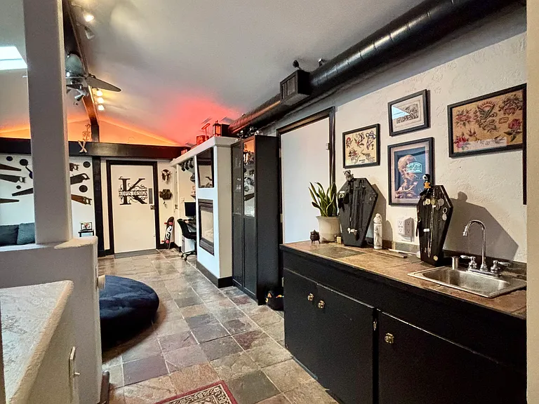Shared den with fireplace, tv, couch, giant bean bag, wet bar