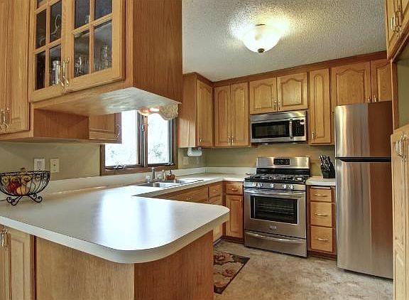 Beautiful kitchen with brand new SS appliances.  You'll finally have the kitchen window you've always wanted overlooking the gorgeous landscaping and very large, very private back yard sanctuary.