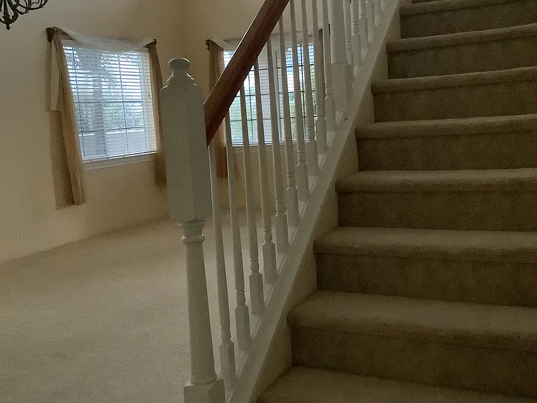 carpeted stair case to upper loft and bedrooms