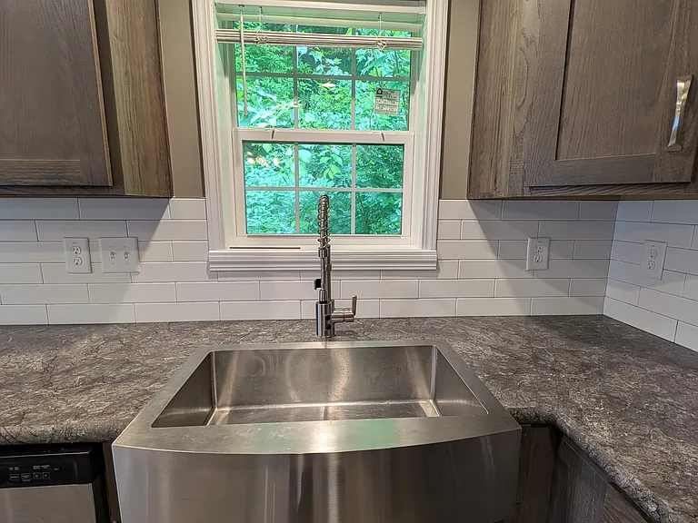 Close up of stainless farmer style sink