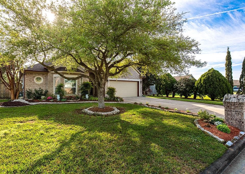 Street view with Large shade tree and beautiful landscaping