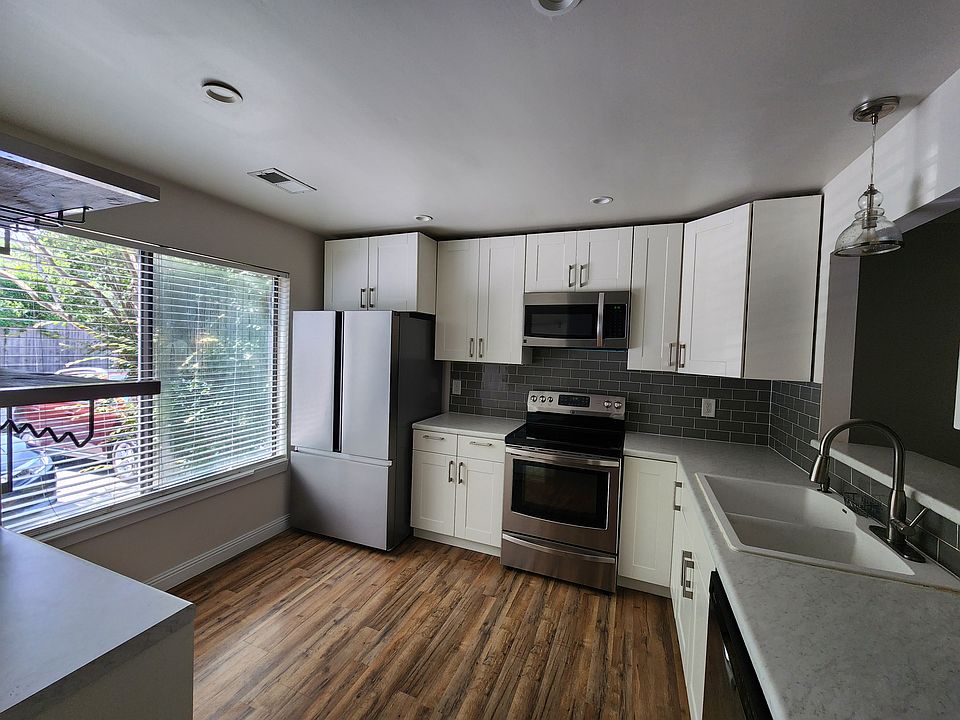 The kitchen has a brand-new refrigerator and dishwasher.