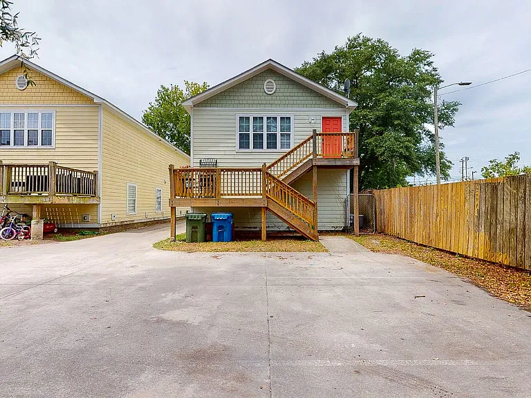 Rear of Duplex showing upstairs neighbors entrance. Lots of shared parking in back.