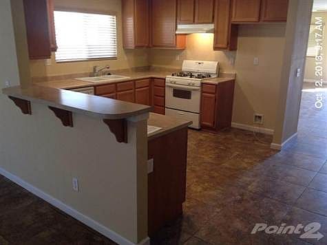 Kitchen has a new garbage disposer, gas range, Hood fan and Dishwasher over Custom Tile Floors...