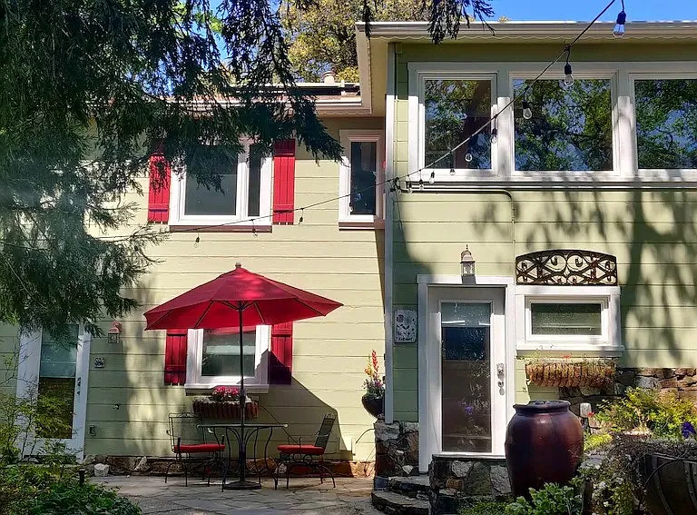 The Studio is the door on the left and the bathroom window is behind the red umbrella.