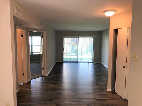 Living area with a large living room with sliding doors to the patio. Coat closet and ft door to the right - MBR and bath to the left.
