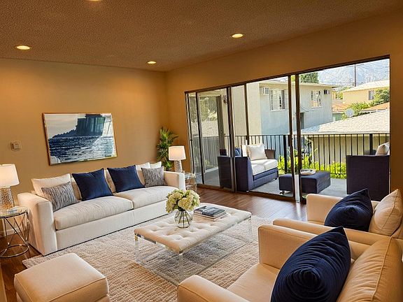 Spacious living room and room-size balcony off living room and back bedroom.