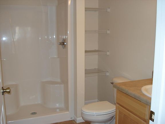 Guest bath with built-in shelving for linens
