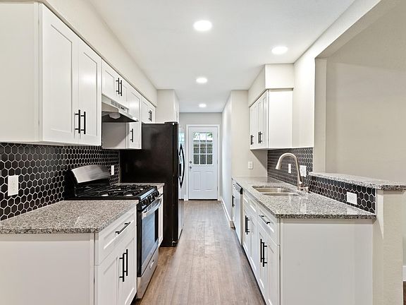 New kitchen with soft-close cabinets, new appliances, pull-down faucet sprayer, and granite countertops.