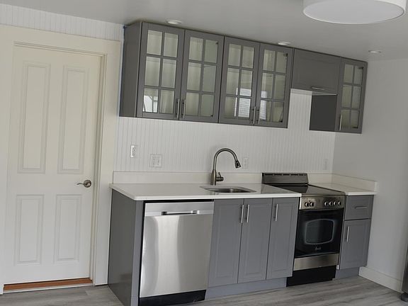 The utility room behind the kitchen holds the full size washer and dryer.