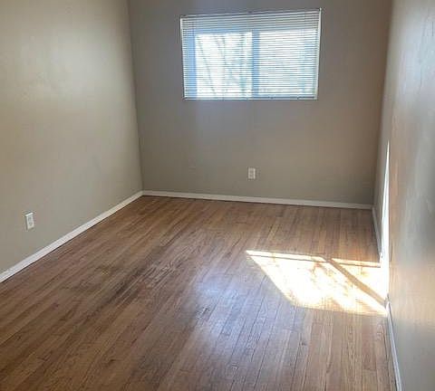 Bedroom with large window allowing natural light in.