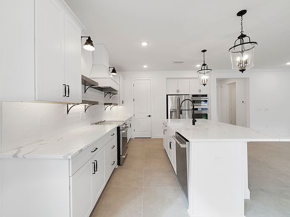 Kitchen with white cabinets and quartz countertops