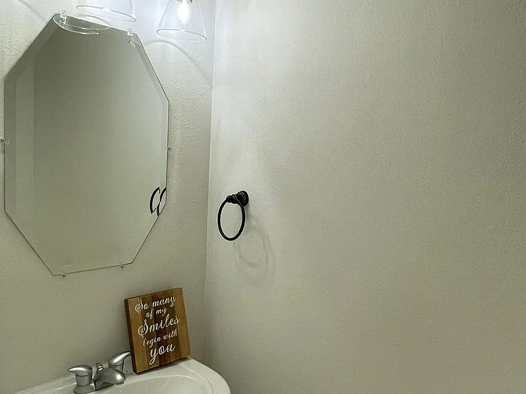 Well-placed half bath provides easy access from the formal dining room and home office.