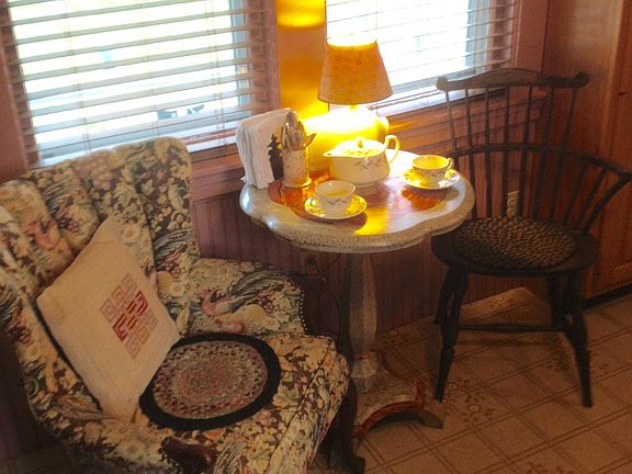 Tea table by the kitchen windows looks out to the deck.