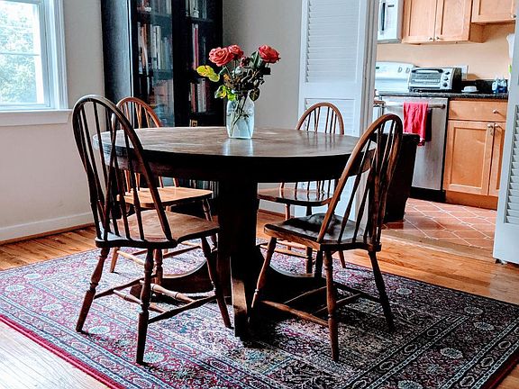 Dining area and part of kitchen. Hardwoods throughout, except for Spanish tile in kitchen.