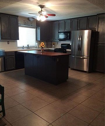 Open kitchen with new refinished wood island.