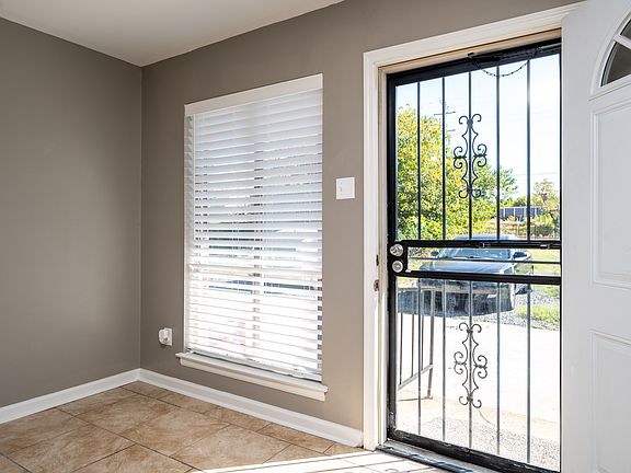 Large 2.5" faux wood blinds cover all windows