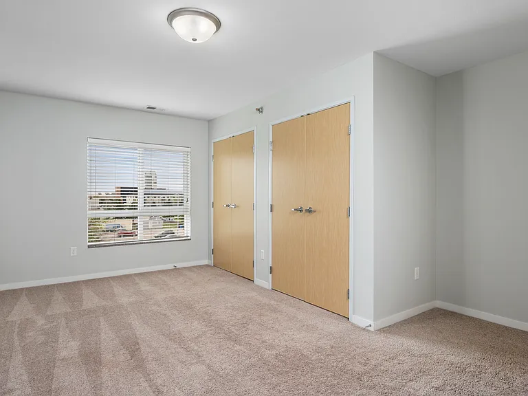 Bright and airy room with plush carpeting and dual closets, ideal for a spacious bedroom or home office. Bright and airy room with plush carpeting and dual closets, ideal for a spacious bedroom or home office.