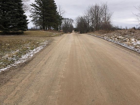 Front road view east, quiet country setting