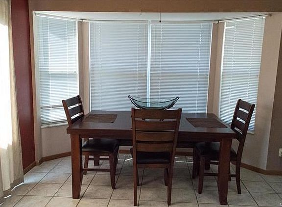 Dining/breakfast room with bay off kitchen with slider to deck is open to great room.