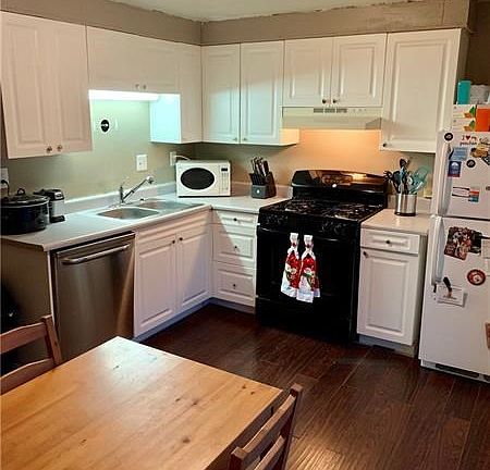Updated kitchen with laminate flooring newer stove and dishwasher. Private patio is located right off the kitchen.