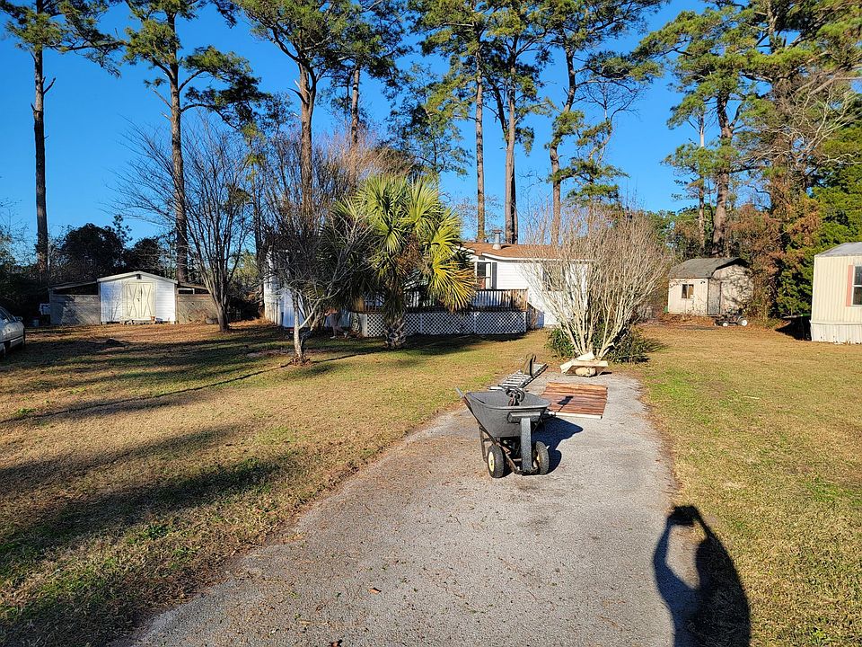 driveway for two cars (beautiful yard with several coastal plants including your very own Palm tree and an XL front porch.