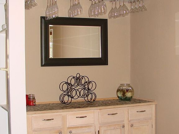 custom cabinets and counter top bar area with glass rack