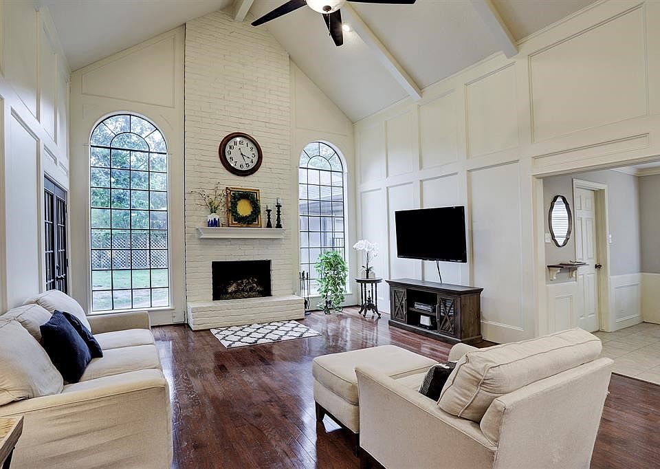 Stunning Showstopping Living Room with High Ceilings, Hardwood Floors, Fireplace and French Doors leading to outdoor patio!