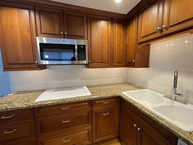 Glass cooktop, under cabinet lighting, storage drawers and pullouts