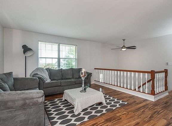 Spacious living room with laminate wood flooring on the whole level.