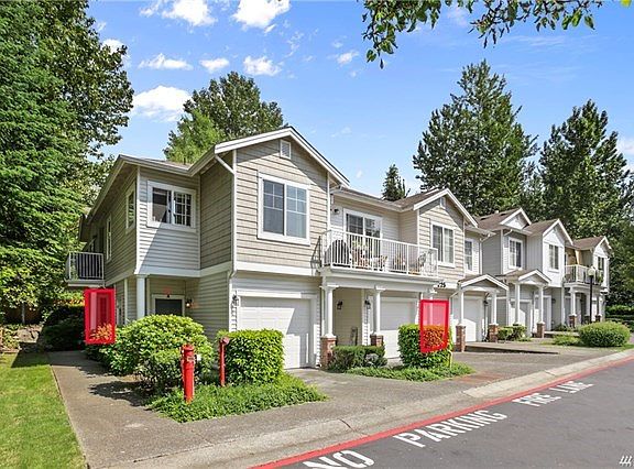 Front view of building showing garage location on right and front door on left. Entry from garage through laundry room.