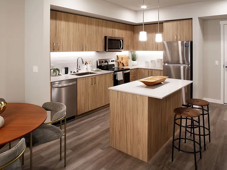 Design Collection II Kitchen with oak cabinetry, white quartz countertops, and white tile backsplash