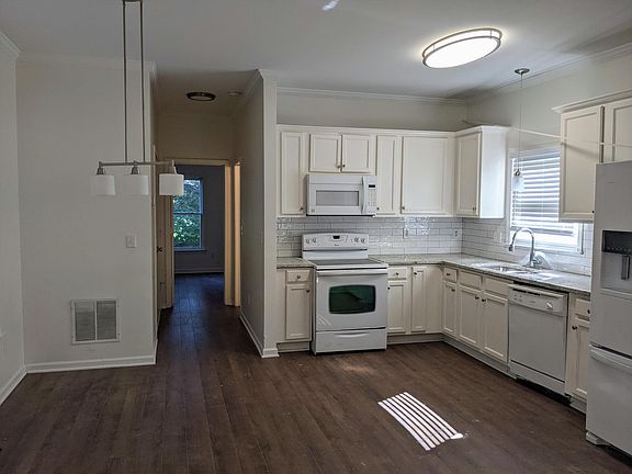 New granite countertops with deep stainless sink and subway tile backsplash.