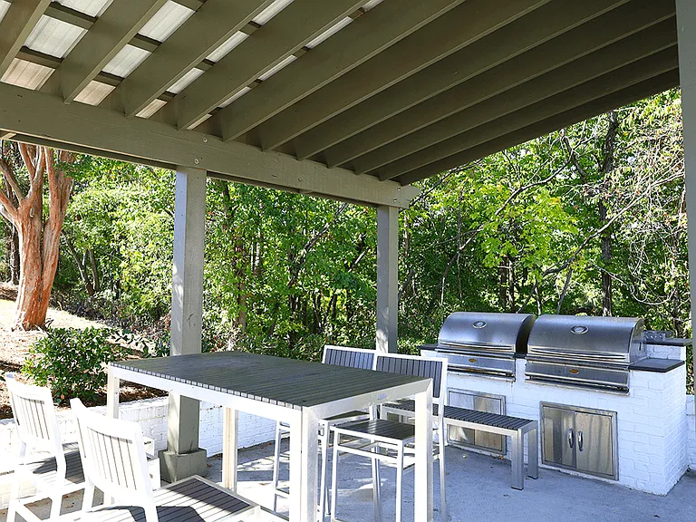 Stainless Steel Grills Underneath a Shade Arbor