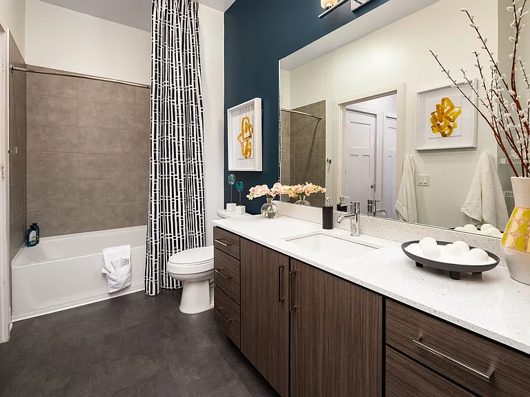 Upgraded Bathroom with Tile Shower, Quartz Countertops, and Sleek Cabinetry