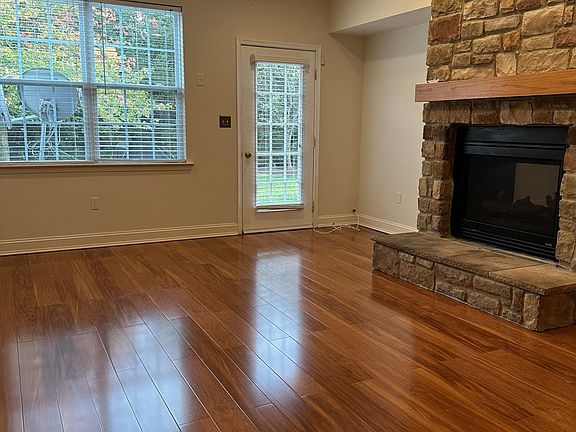 Family Room, Brick Fireplace, Wooden Flooring, Backyard Door