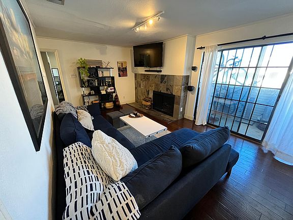 Large open living room with fire place and adjacent patio.