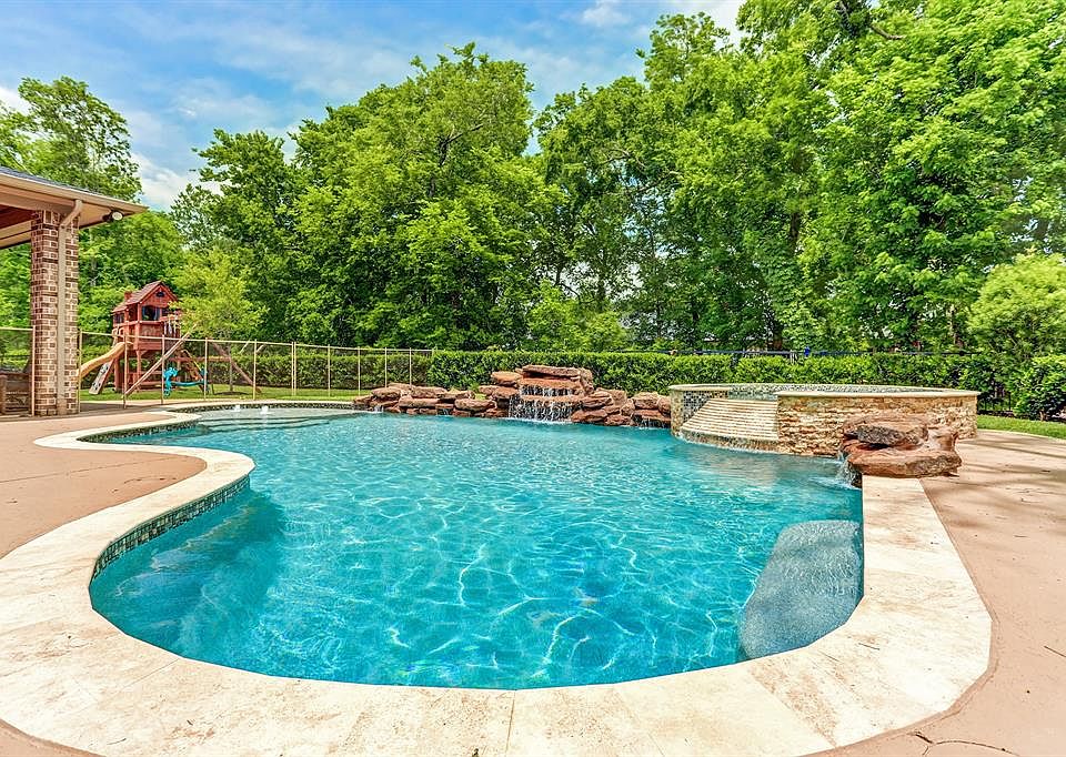 9511 Plaza Point is the place to be this summer! Beautiful sparkling pool with raised spa and rock waterfall feature. Decking area and green space provides you a break from the water activities. All this in the privacy of your backyard with mature tr