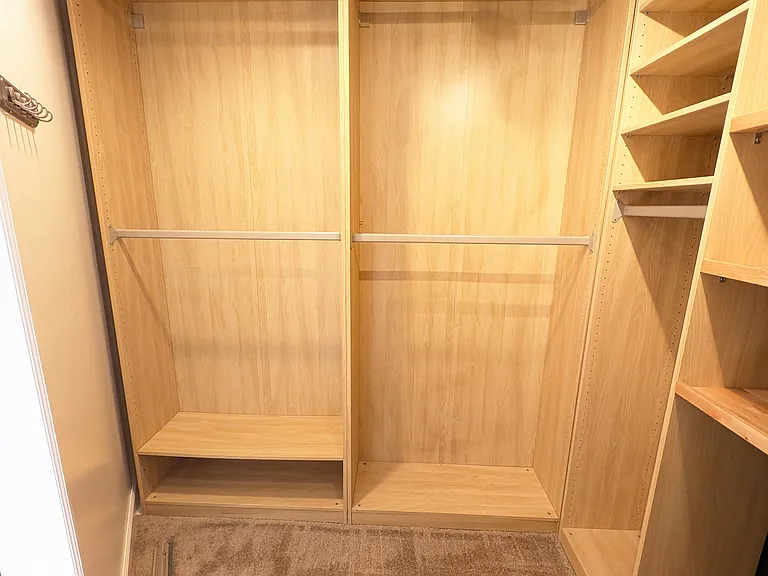 Large master closet with customizable closet system.