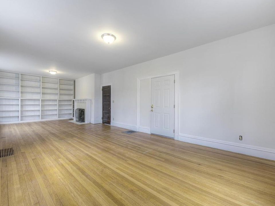 Large Living/Dining Area with Fireplace and Built In Bookcas