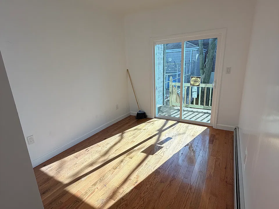 Bedroom with access to deck and backyard