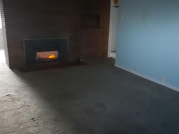 Living room, to be newly painted & carpeted before new occupancy