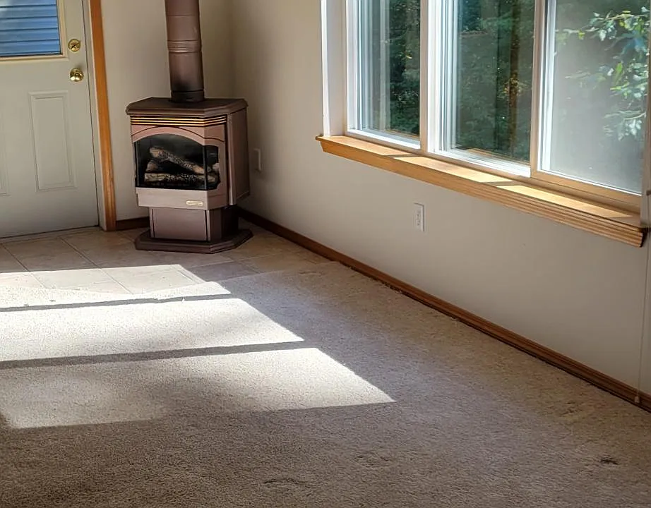 Main living area with large south facing windows and door to large balcony.